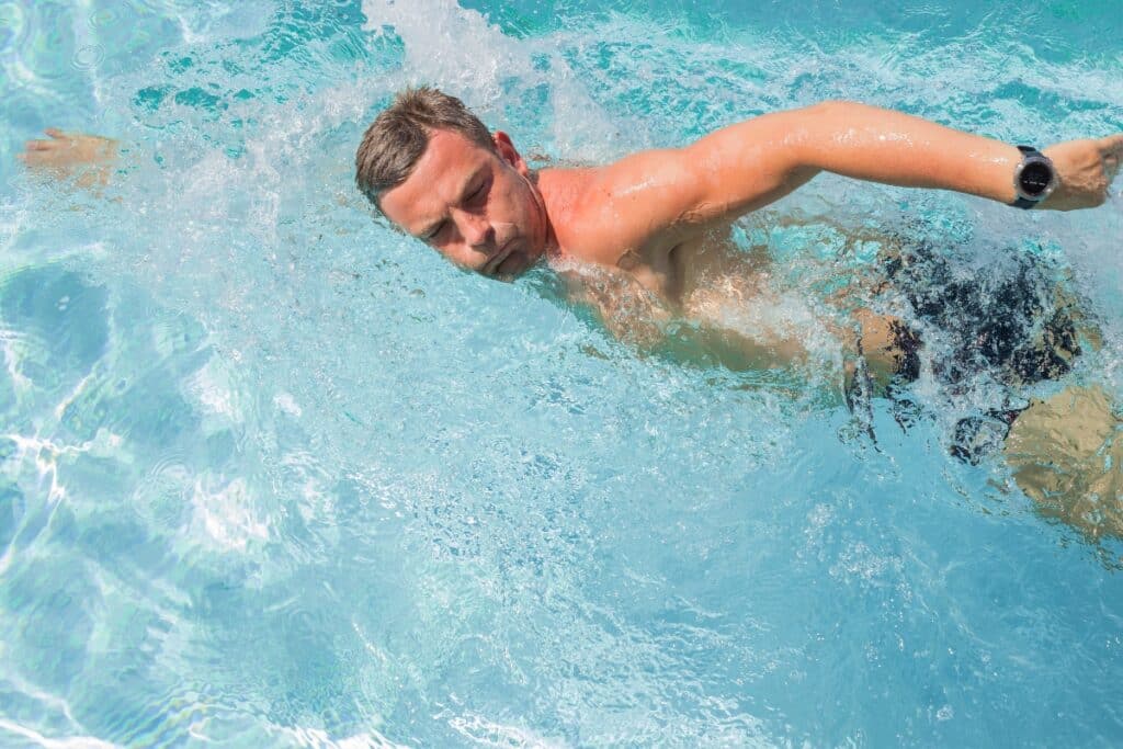 man swimming for cardio exercise